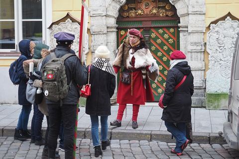 Tour guide with a group in an old town